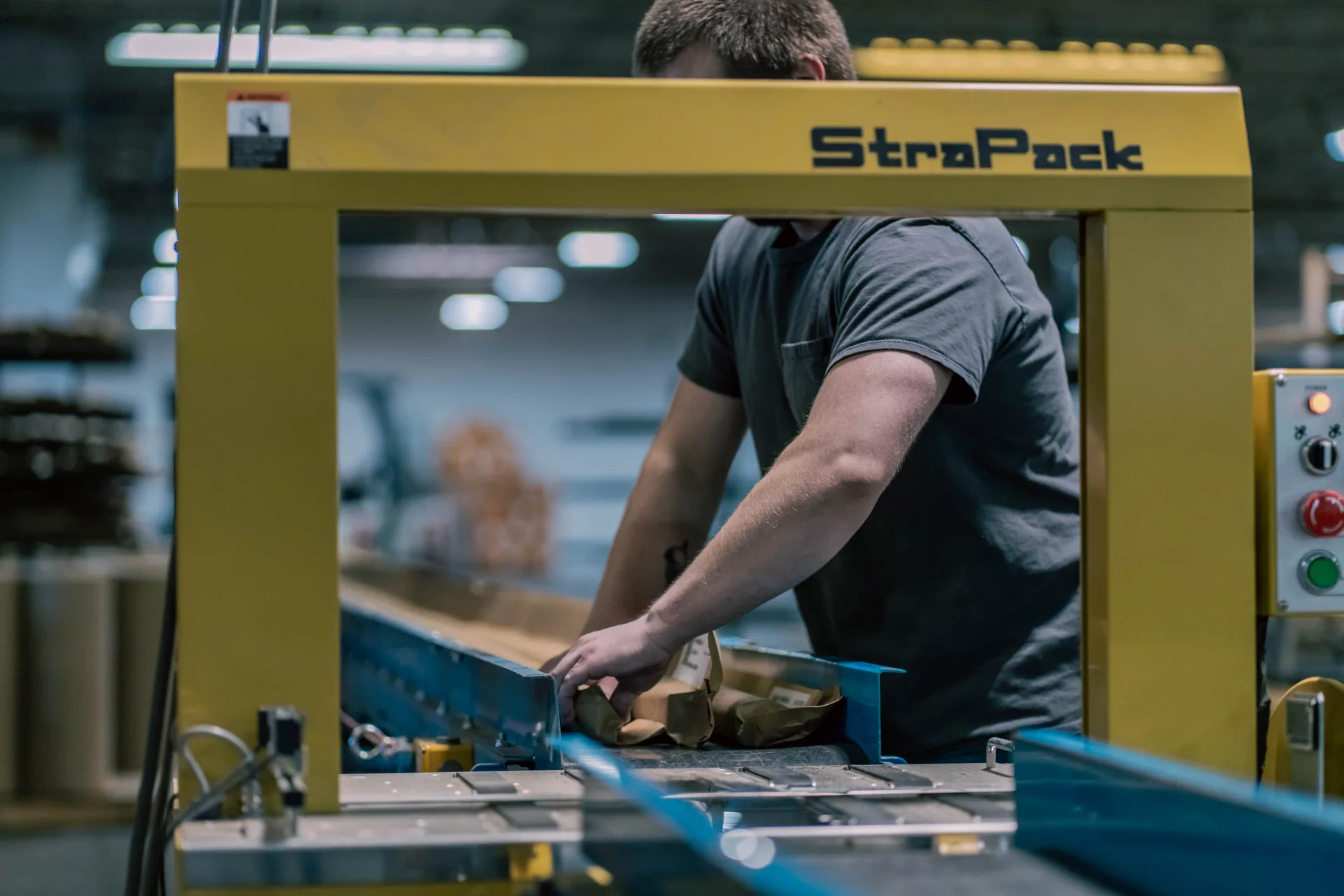 StraPack strapping machine operator packaging metal profiles, Goshen Manufacturing Company